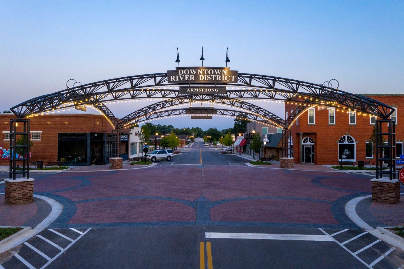The Downtown River District arch in Bixby at dusk