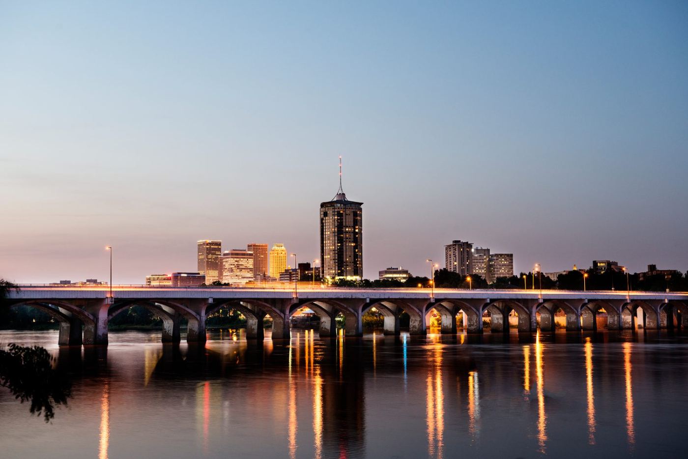 The Tulsa skyline at dusk across the Arkansas River